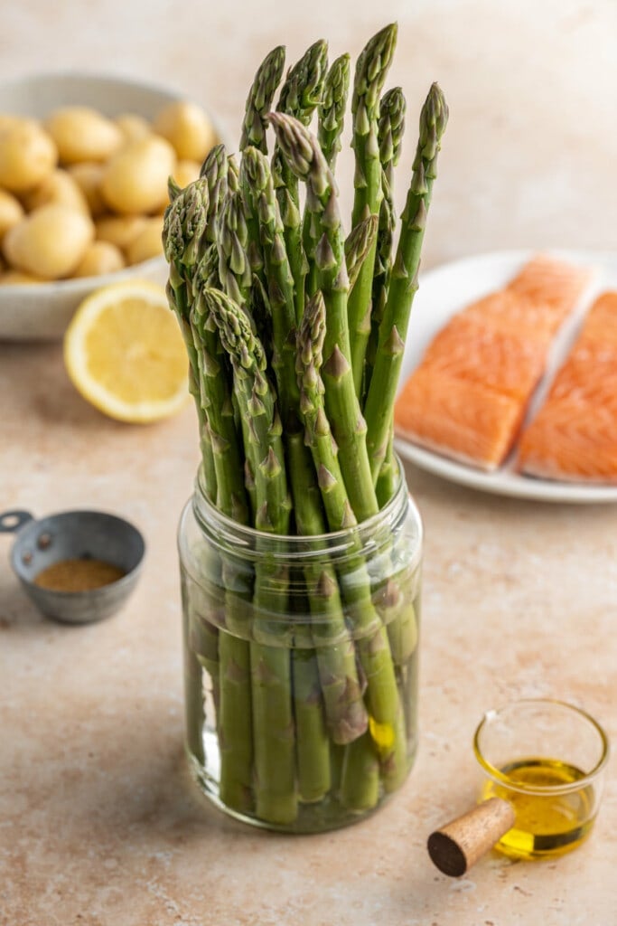 Storing asparagus before use in sheet pan salmon dinner.