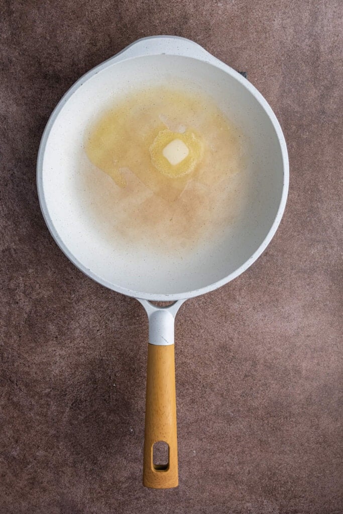 Butter melting in hot pan before adding silver dollar pancake batter.