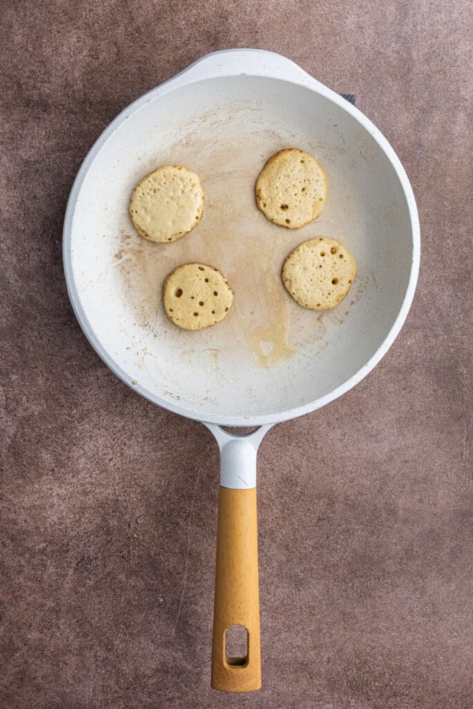 Silver Dollar Pancakes frying in pan ready to flip