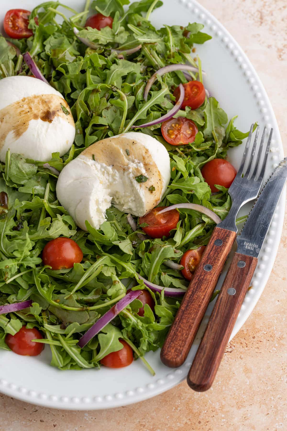 Close up of Arugula Burrata Salad with burrata sliced into