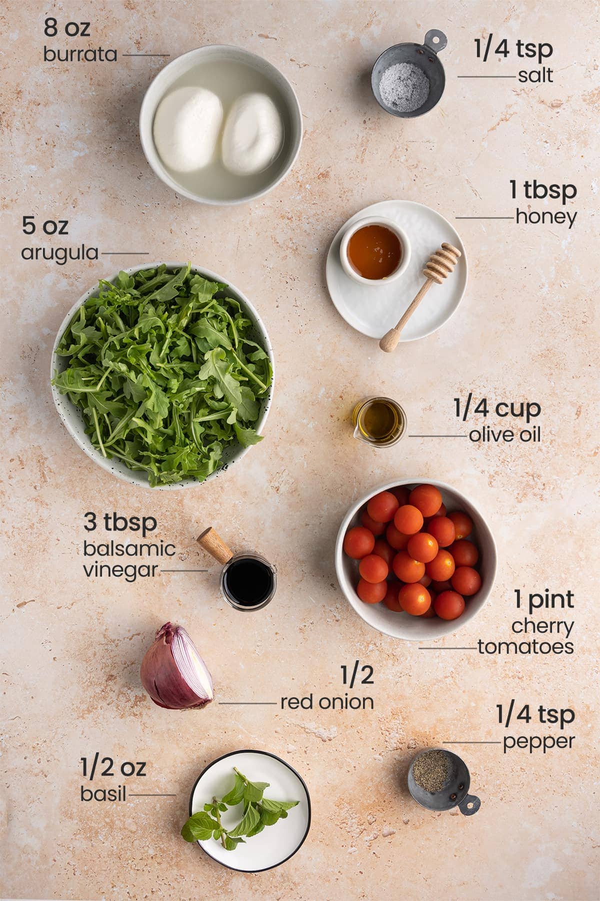 ingredients for arugula burrata salad - salt, burrata, arugula, honey, olive oil, balsamic vinegar, cherry tomatoes, red onion, basil, pepper