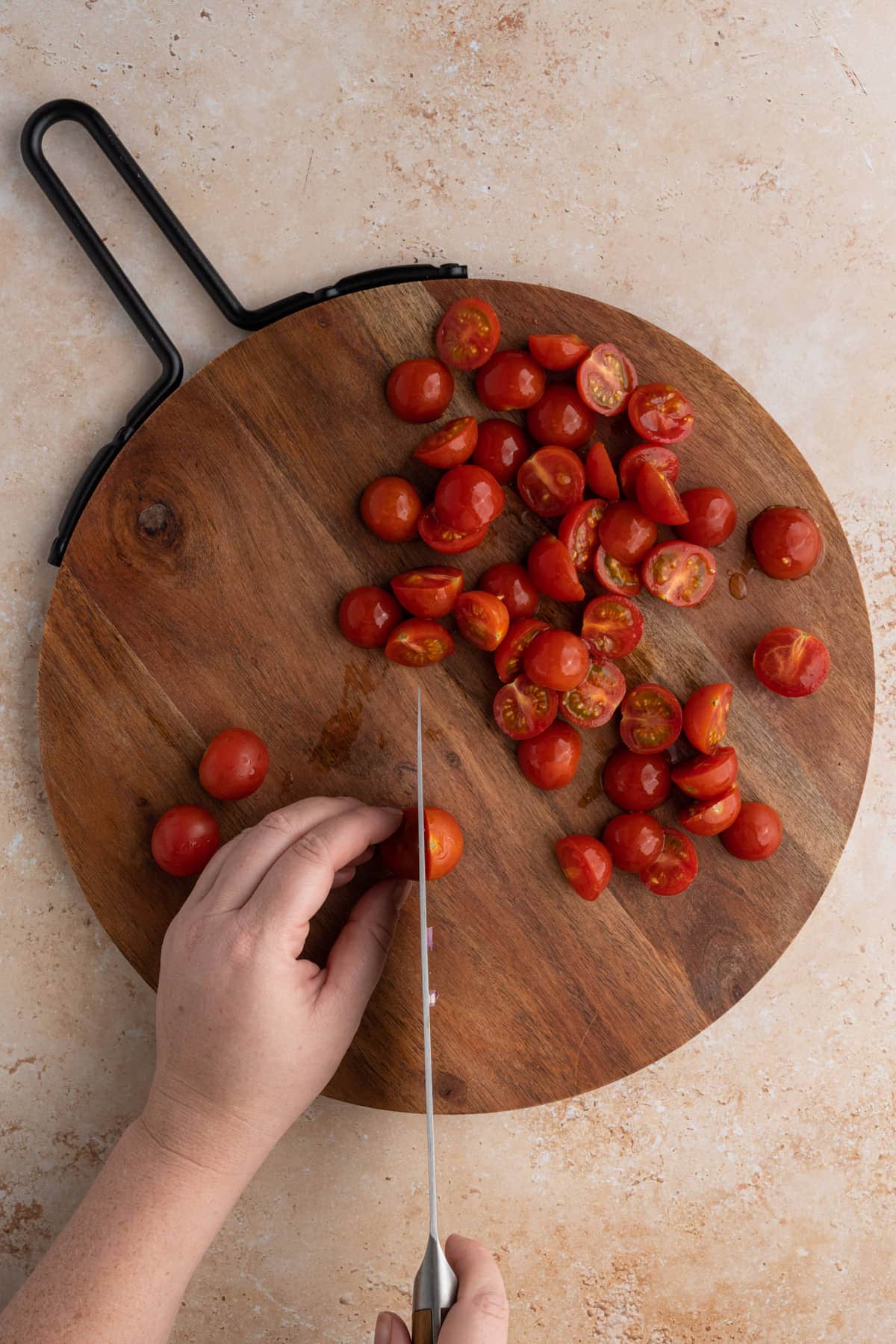 Slicing grape tomatoes in half lengthwise