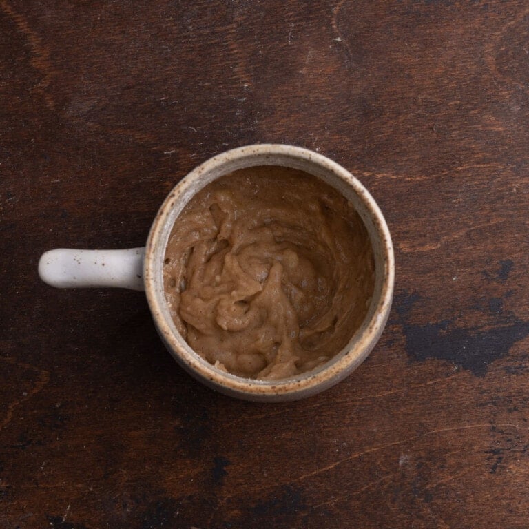 Banana bread batter in a mug after adding dry ingredients