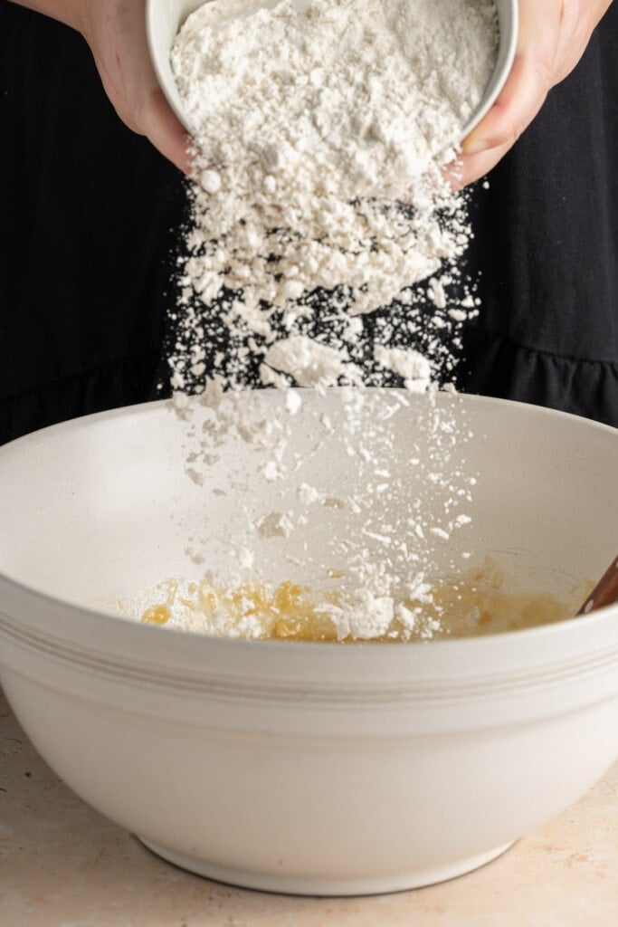 Adding dry ingredients to batter for Zucchini Banana Bread.