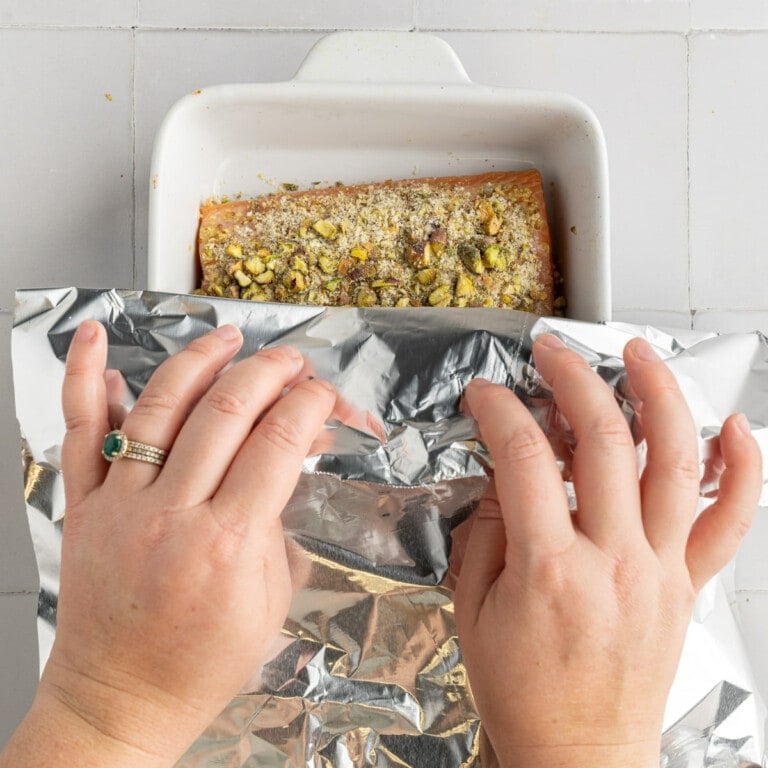 Using aluminum foil to cover Pistachio Crusted Salmon for first half of baking