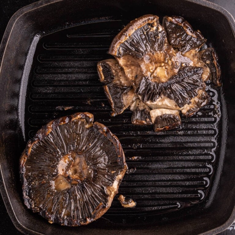 Flipping and grilling portobello mushrooms on a grill pan again