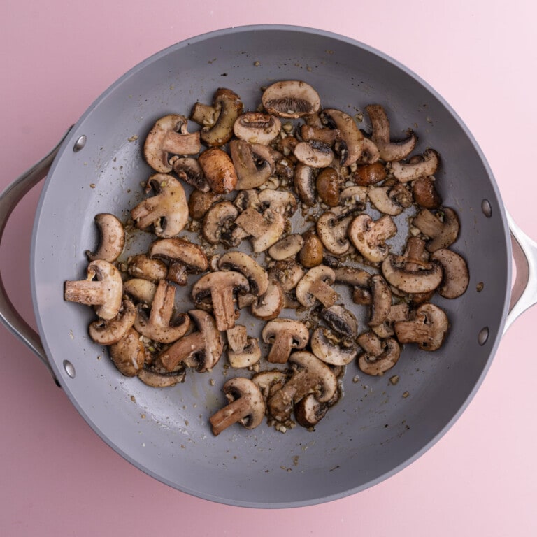 Mushrooms and garlic sautéing in pan