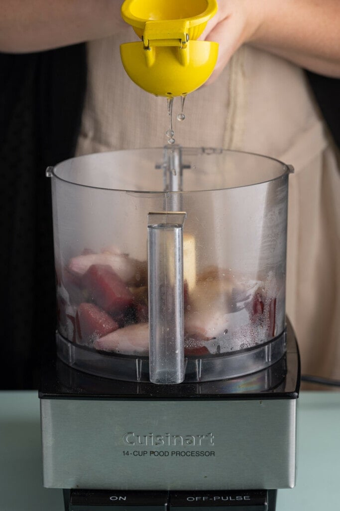 Adding fresh lemon juice to pink pasta sauce.