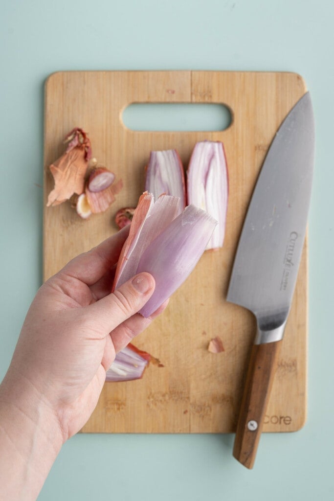 Peeling and discarding outermost layer of shallot