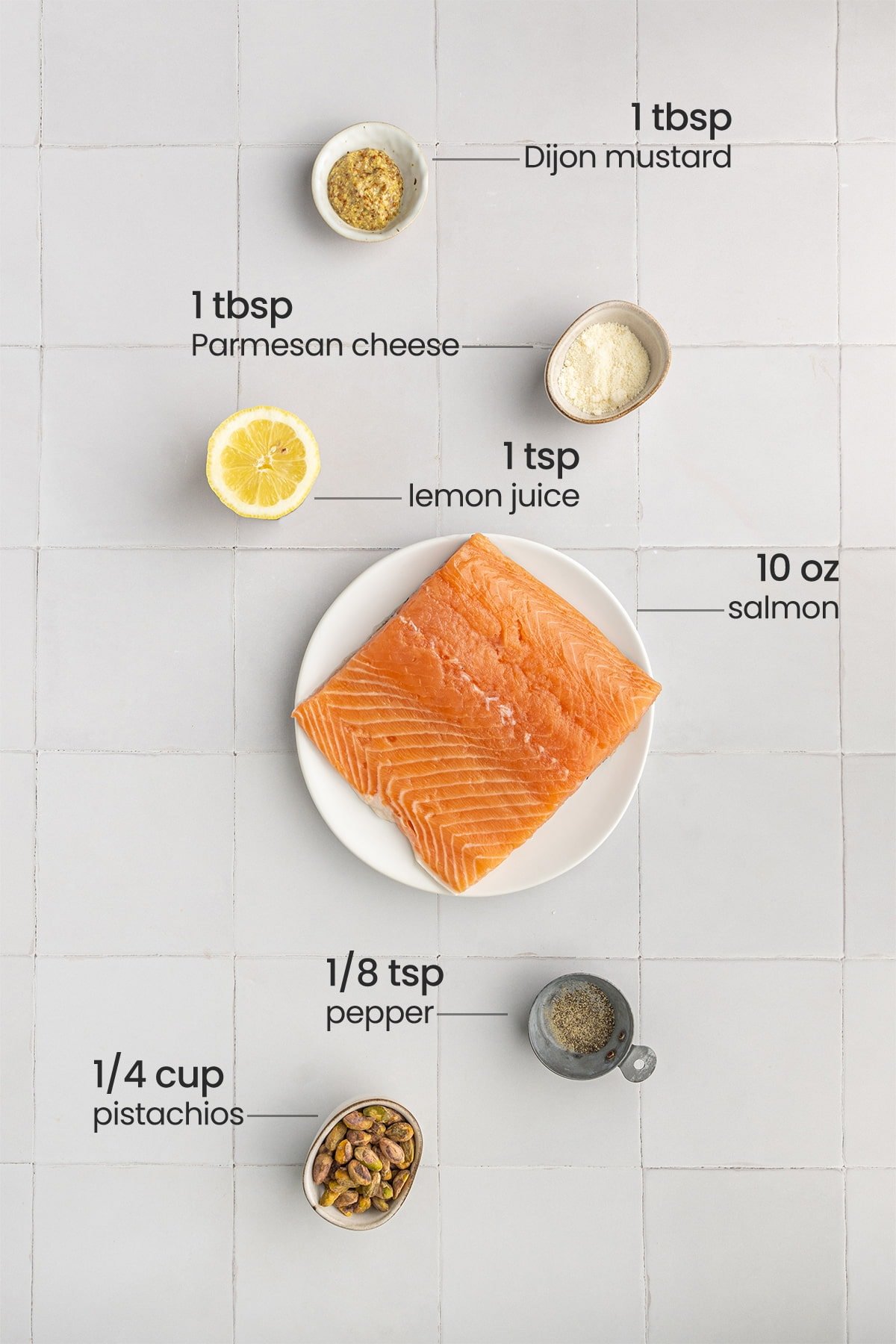 ingredients needed for pistachio crusted salmon - Dijon mustard, Parmesan cheese, lemon juice, salmon, pepper, pistachios