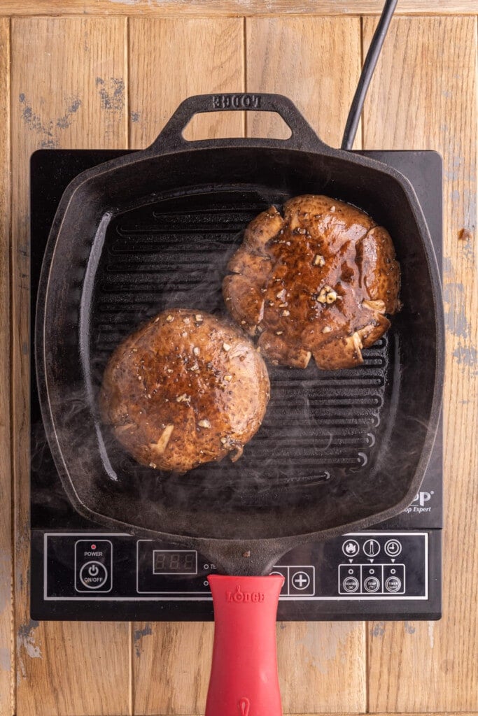 Placing portobello mushrooms face down on grill pan