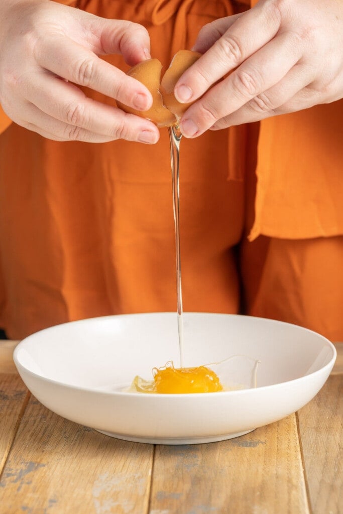 Cracking egg into bowl to make egg wash