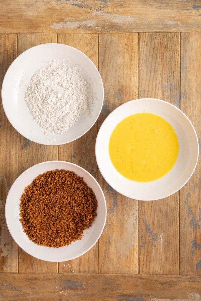 Setting up assembly of flour, egg wash, and toasted panko breadcrumbs.