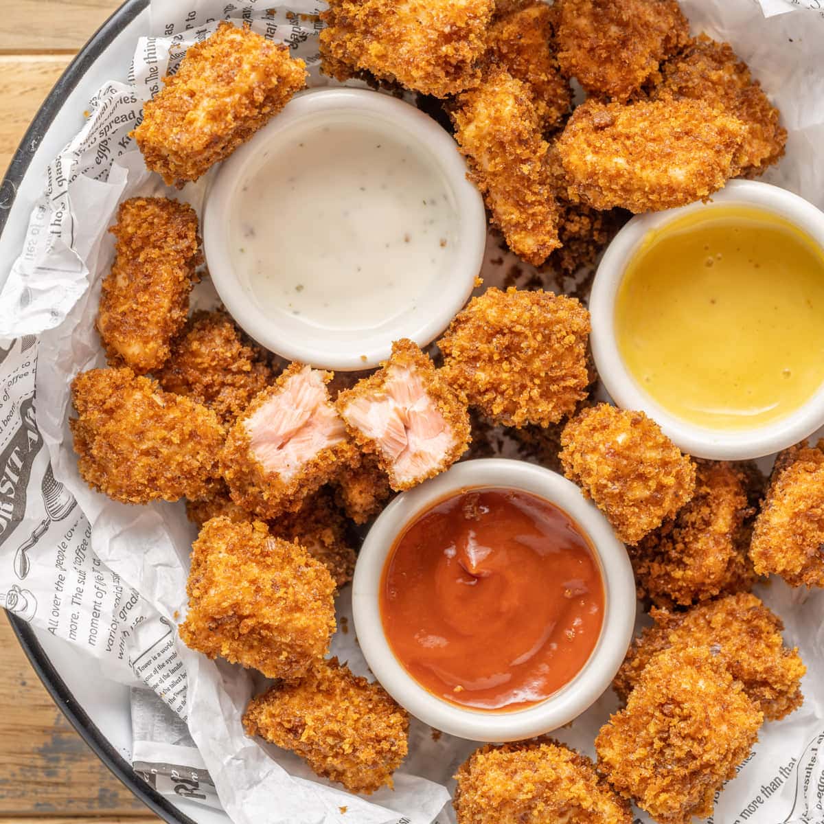 Salmon Nuggets in a basket with 3 sauces