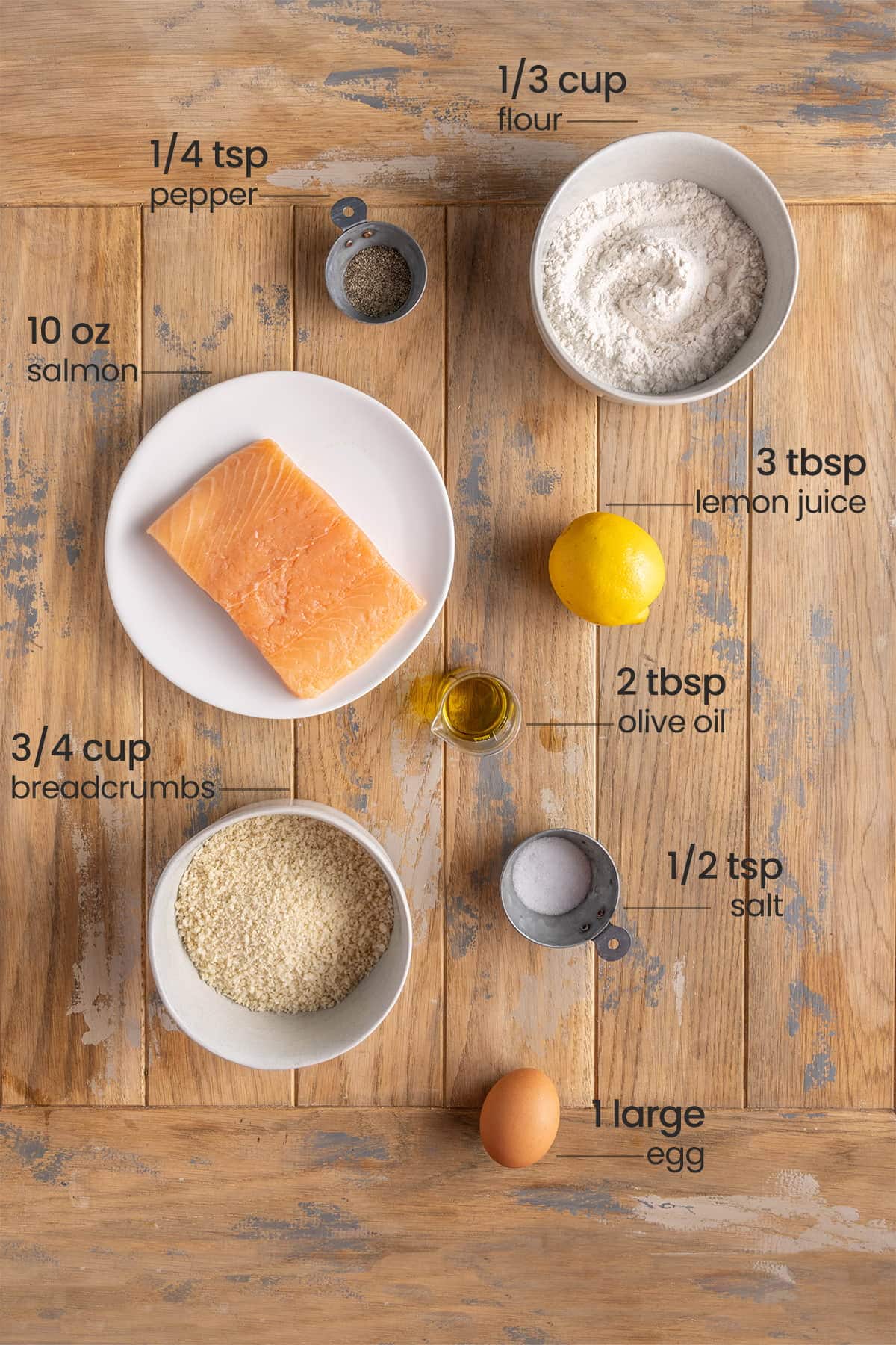 ingredients for salmon nuggets - flour, pepper, salmon, lemon juice, olive oil, breadcrumbs, salt, egg