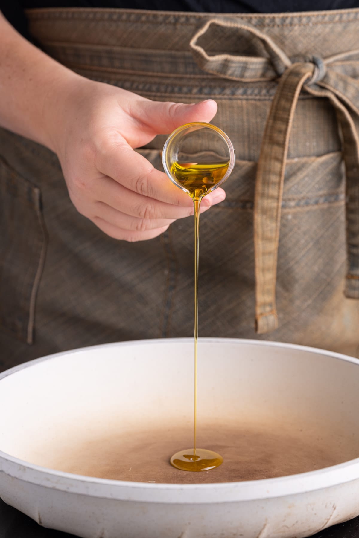 Adding olive oil to a pan to get hot before blackening salmon in it