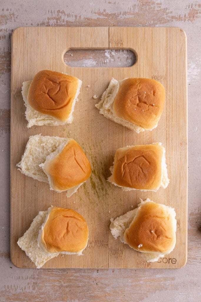 Slicing King Hawaiian rolls in half