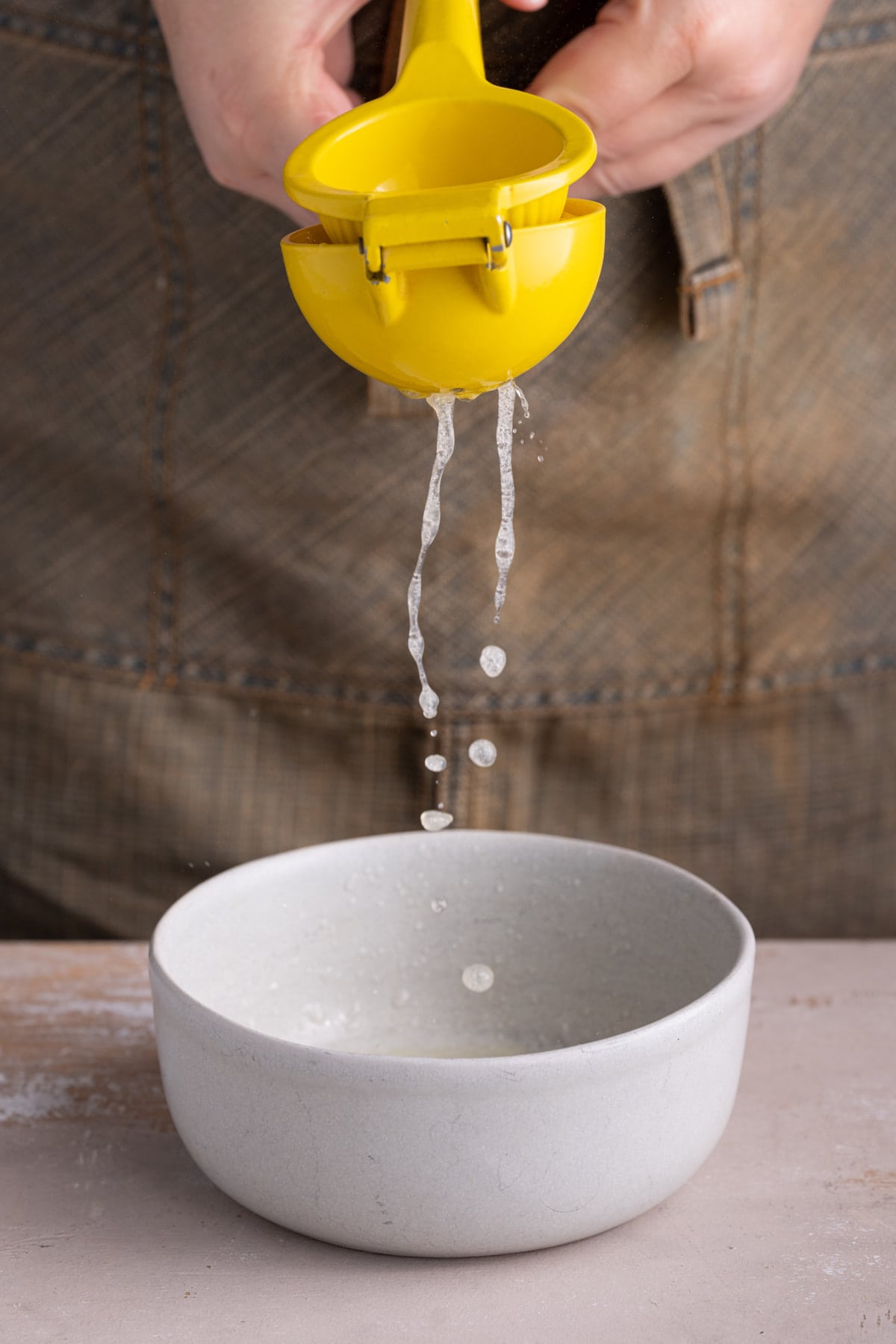 Squeezing fresh lemon juice into Greek Yogurt sauce