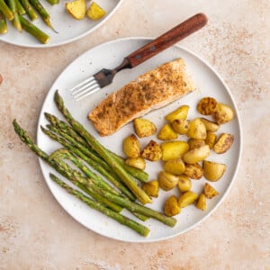 Sheet Pan Salmon Asparagus and Potatoes on a plate with a fork