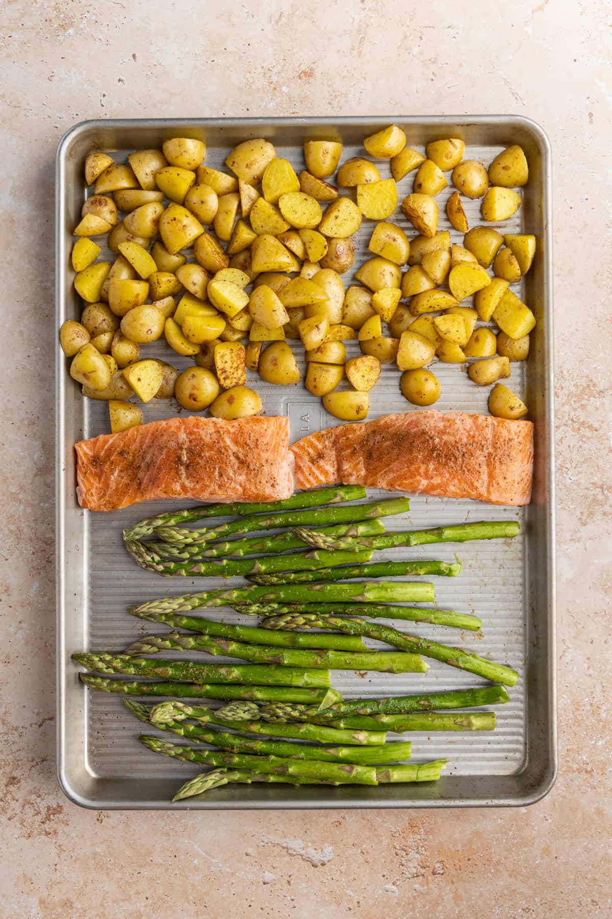 Salmon Asparagus and Potatoes on a sheet pan ready for the oven