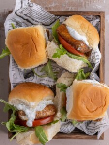 4 Salmon Sliders on a wooden tray