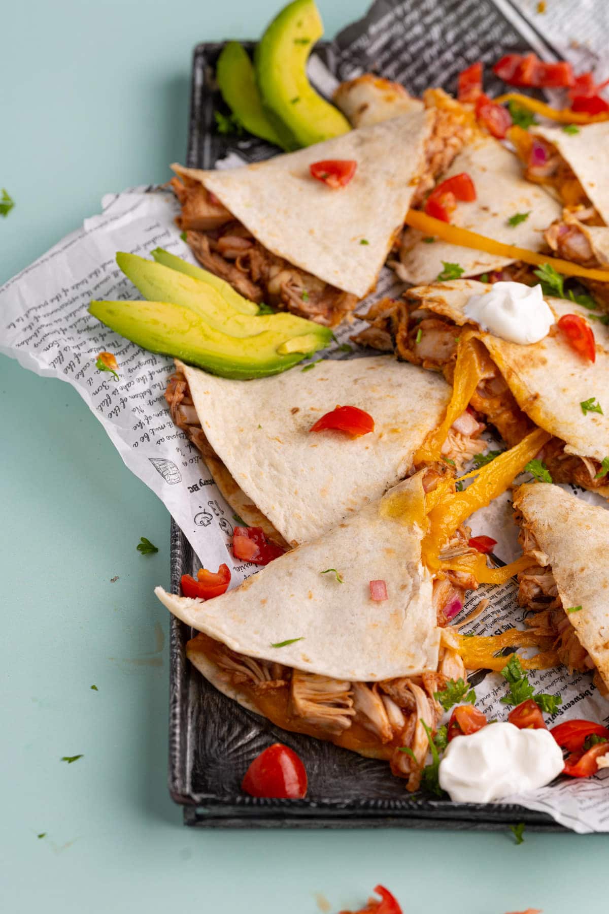 BBQ Jackfruit Quesadilla served with sour cream, avocado, and diced tomatoes