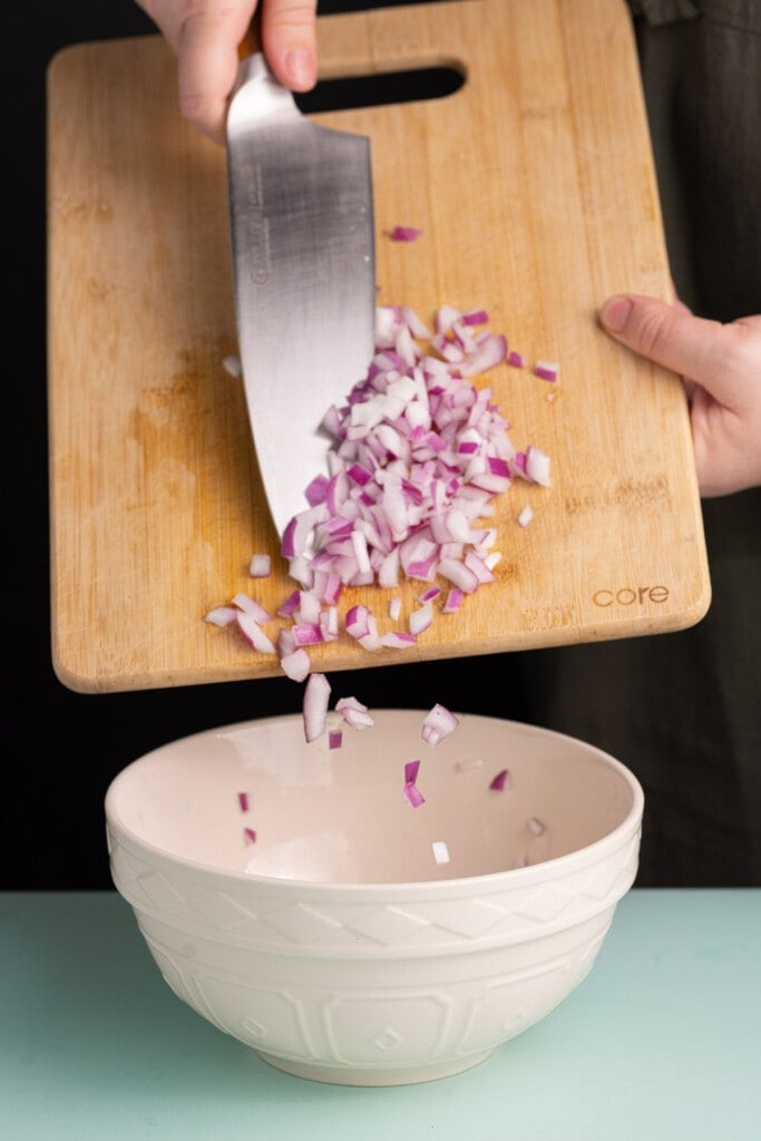 Adding diced red onion to BBQ jackfruit for crunch