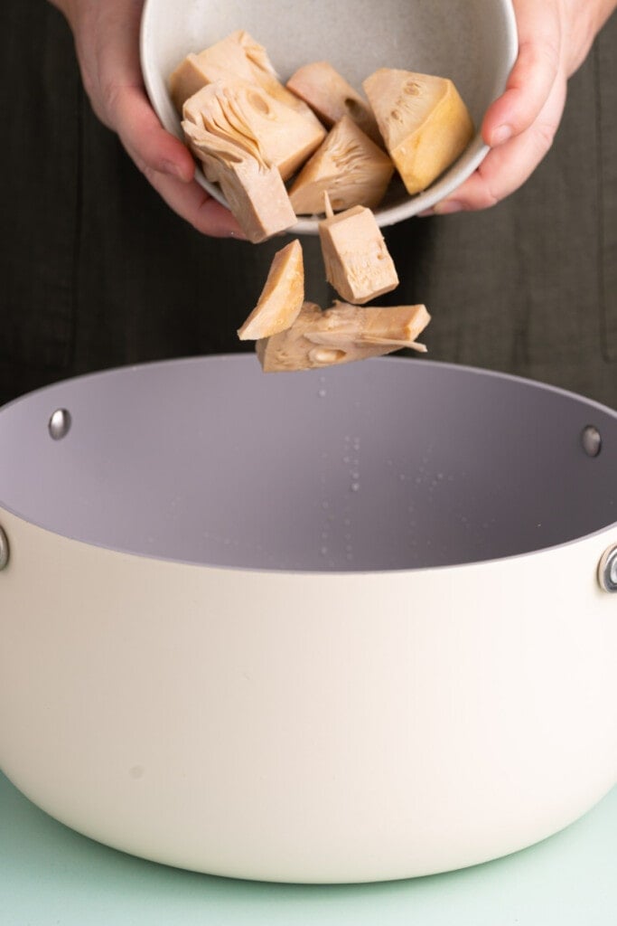 Adding canned jackfruit to boiling water to tenderize