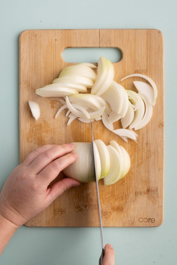 Laying onion flat on cutting board to easily slice