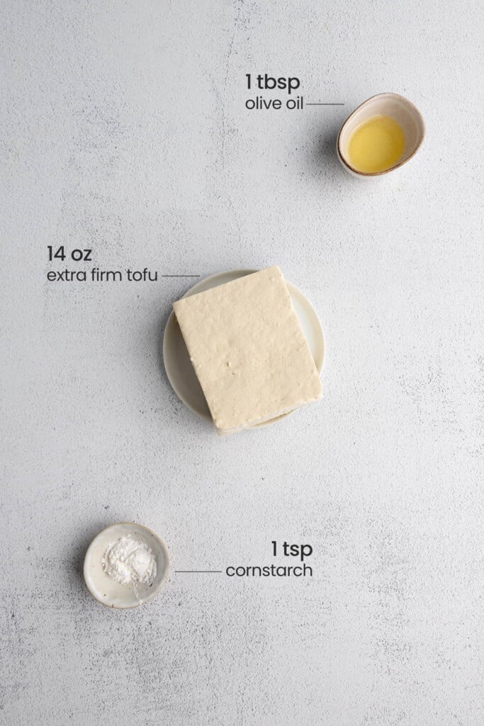 Olive oil, extra firm tofu, cornstarch to show everything you need to make crispy tofu.