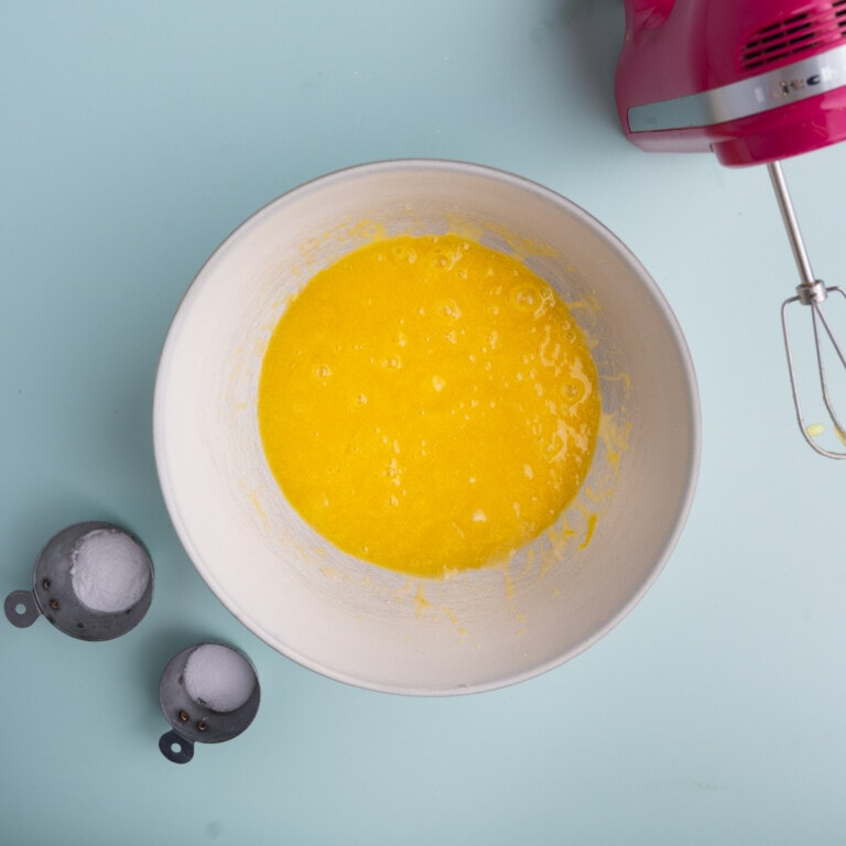 Eggs, vanilla extract, olive oil, and sugar creamed together in a bowl