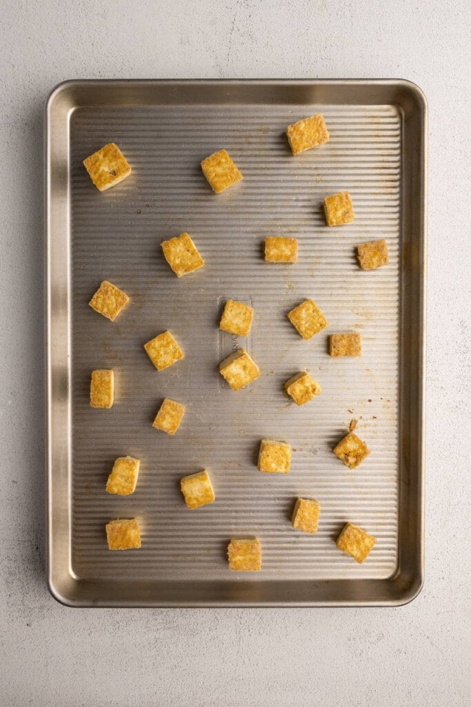 Crispy baked tofu still on baking sheet
