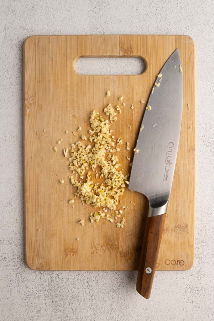 Freshly minced garlic on a cutting board