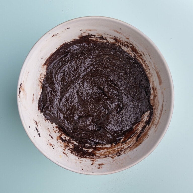 Thick olive oil brownie batter in a bowl