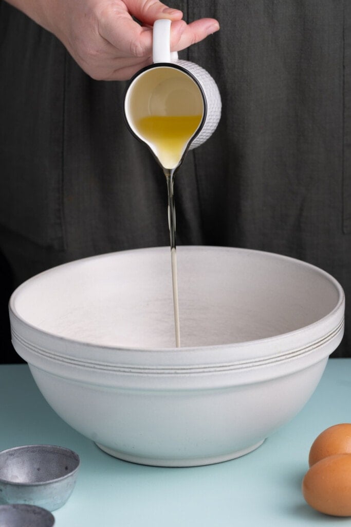 Adding olive oil to large mixing bowl