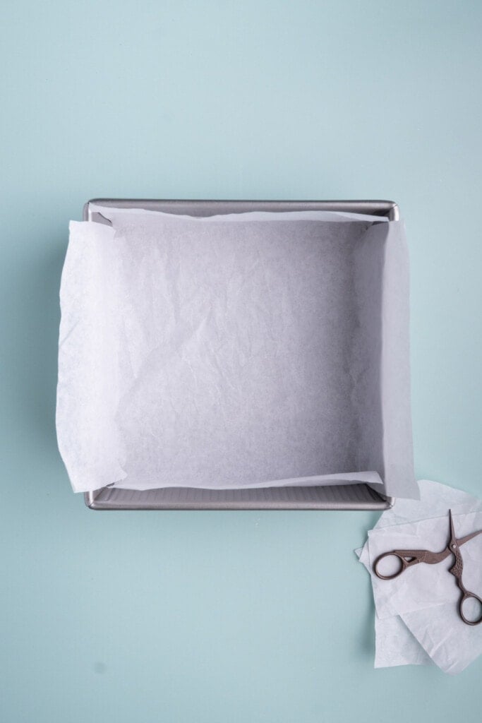 Lining a brownie pan with parchment paper