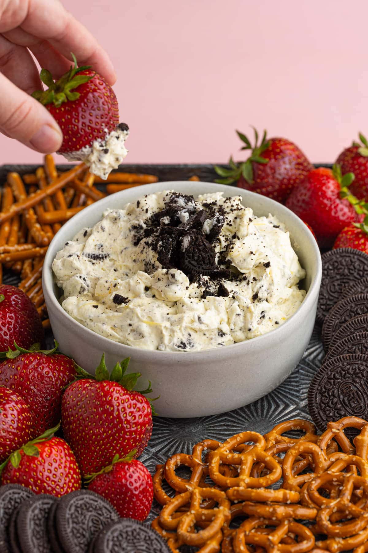 Dipping a strawberry into Oreo Dip