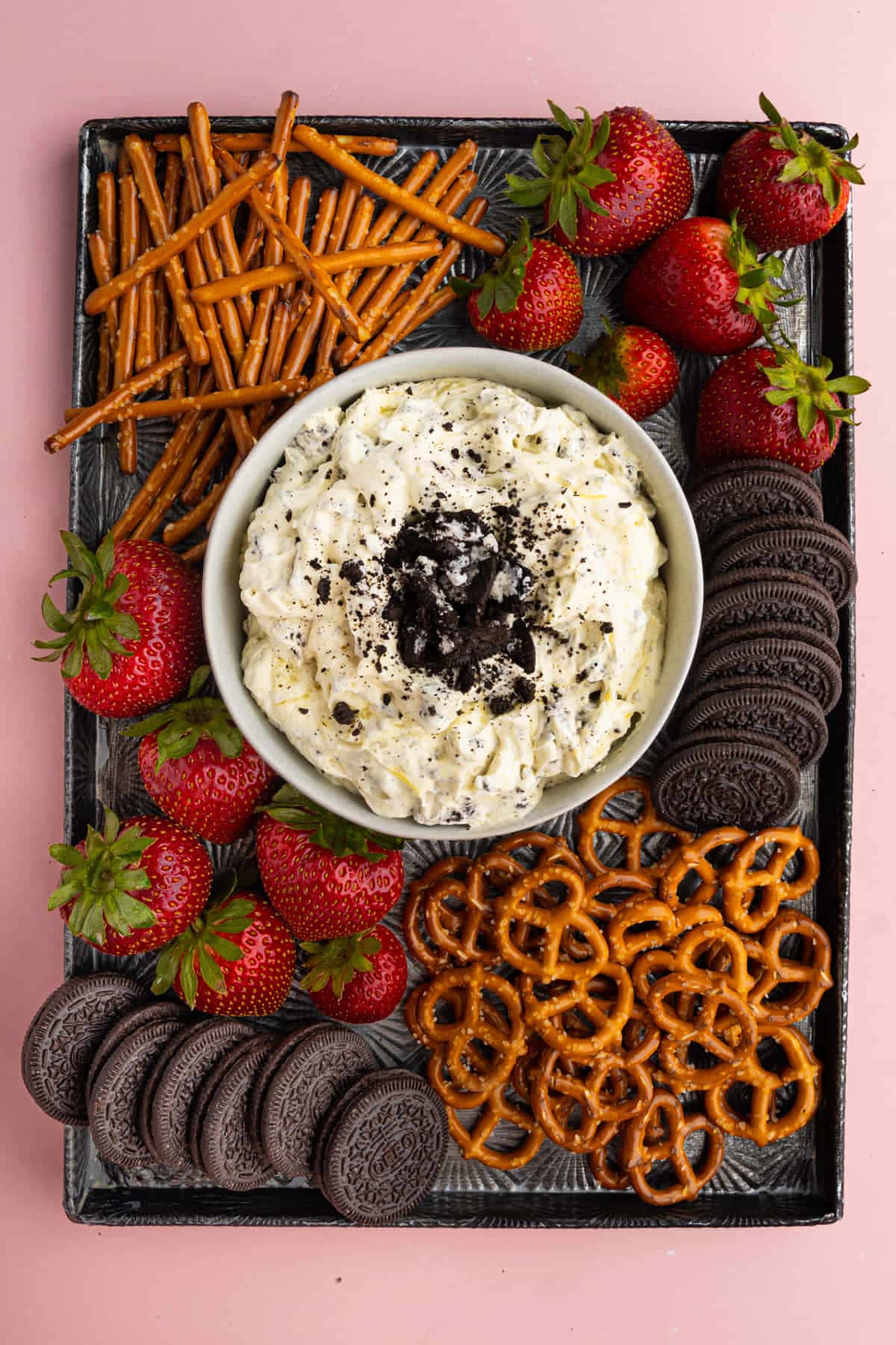 Cookies and Cream Dip served on a tray with pretzels and fruit