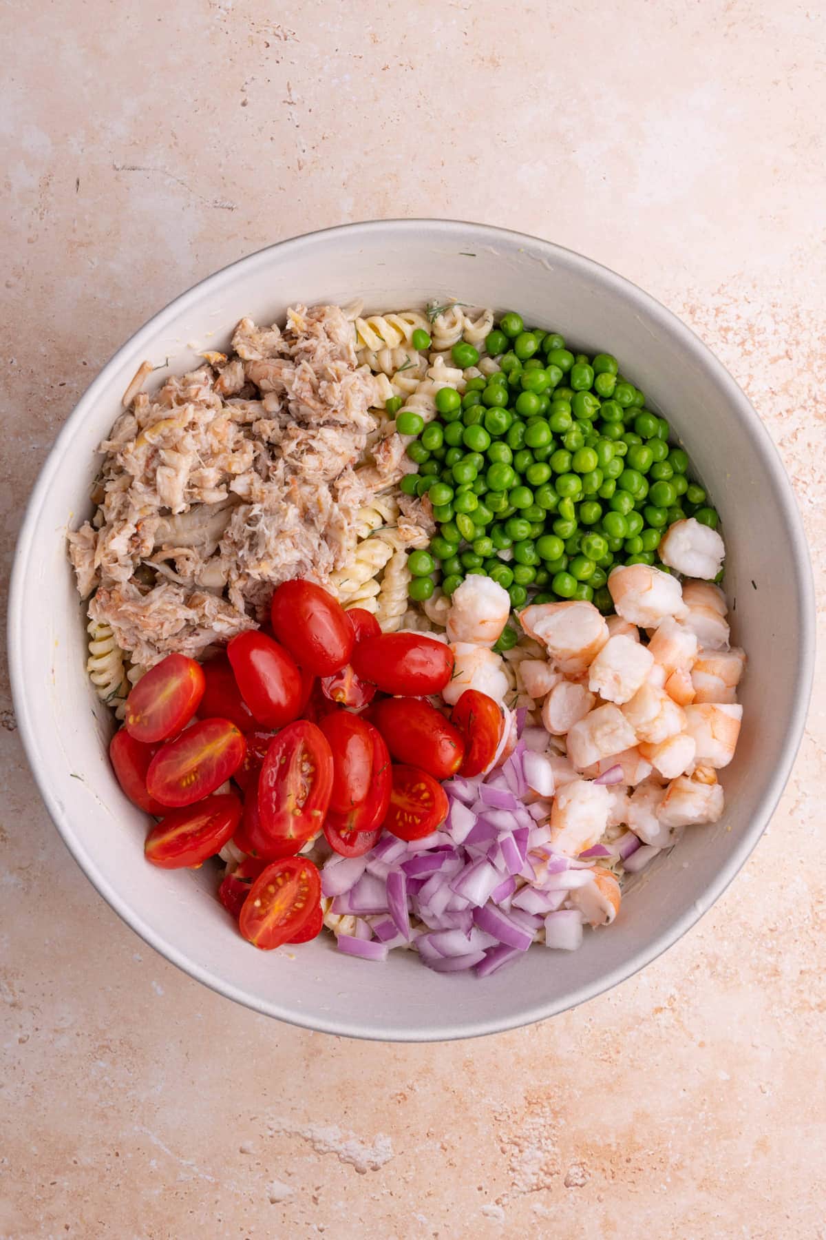 Crab meat, peas, tomatoes, red onion, and shrimp atop dressed pasta