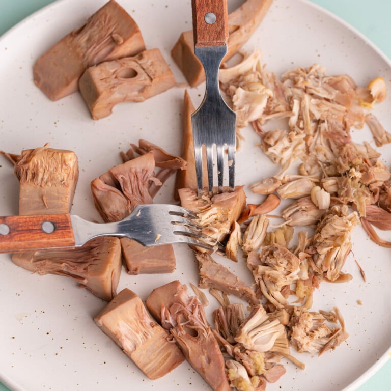 Using two forks to shred boiled jackfruit