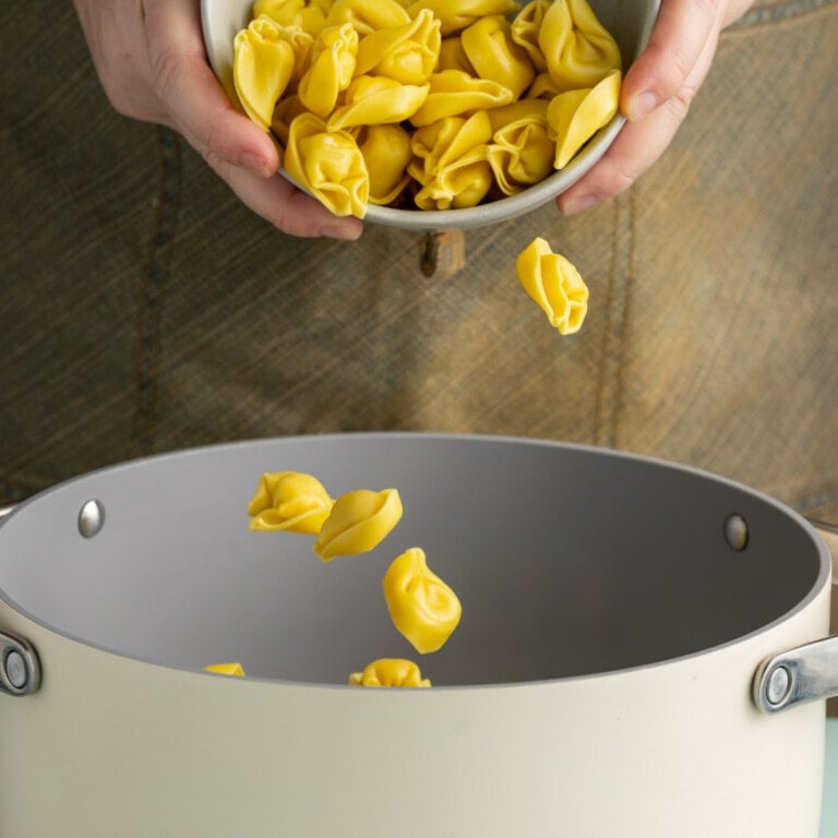 Adding fresh tortellini to gently boiling water