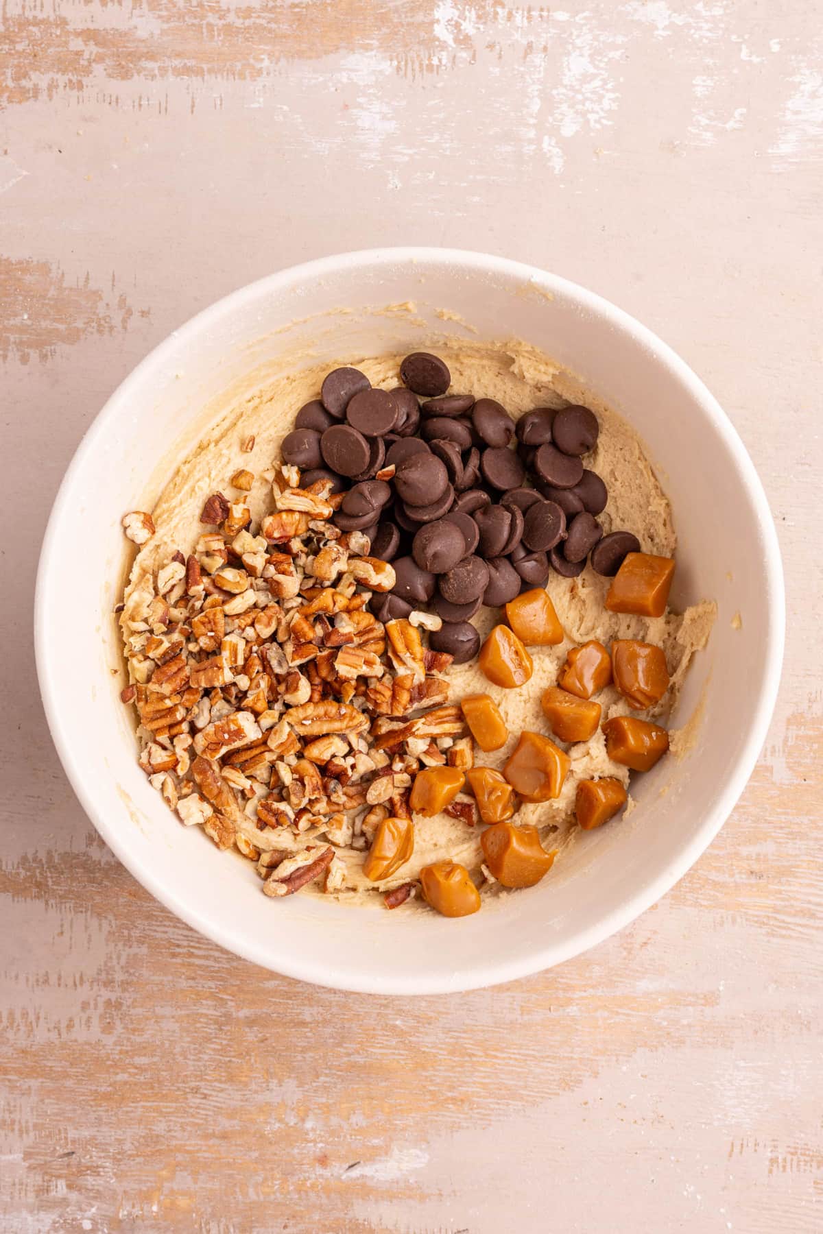 Cookie dough with chewy caramels, chocolate chips, and chopped pecans