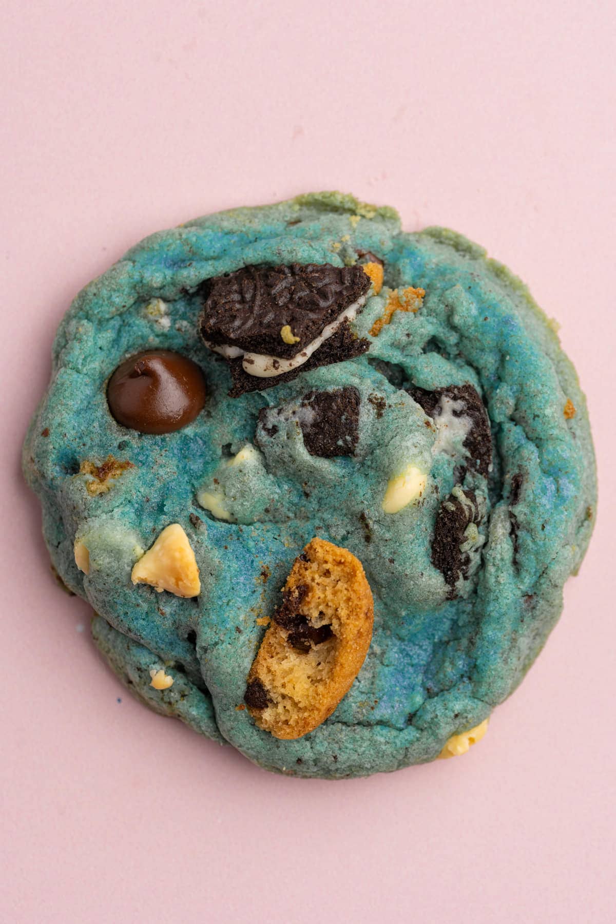 Close up of a blue Cookie Monster cookie on a pink background