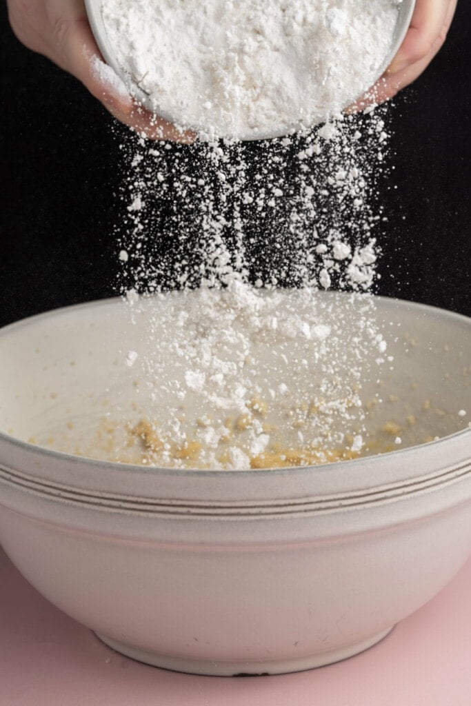 Adding flour to Cookie Monster cookie dough with the other dry ingredients.