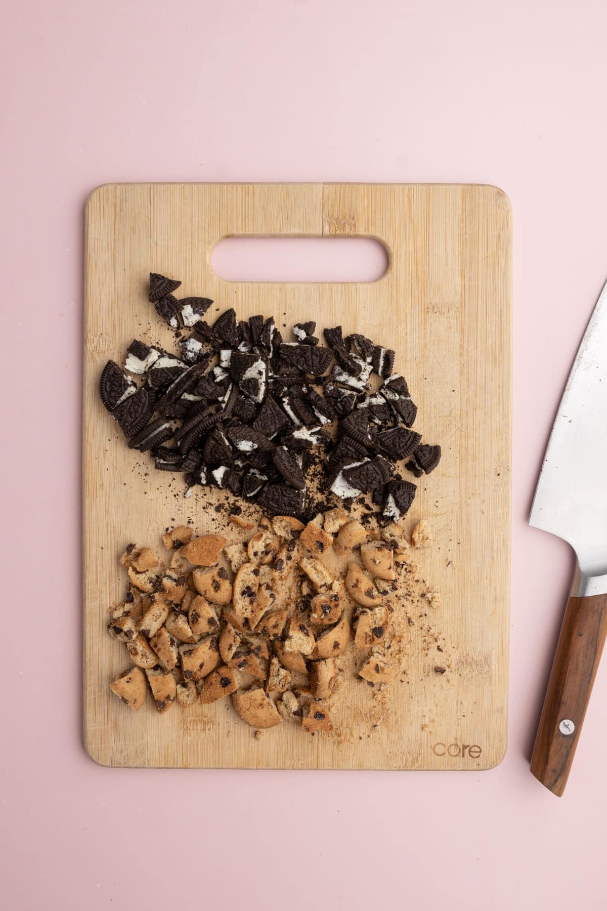 Using a sharp knife to chop Oreos and Chips Ahoy to mix into cookie dough