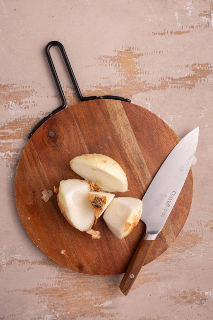 Cutting yellow onion around the core