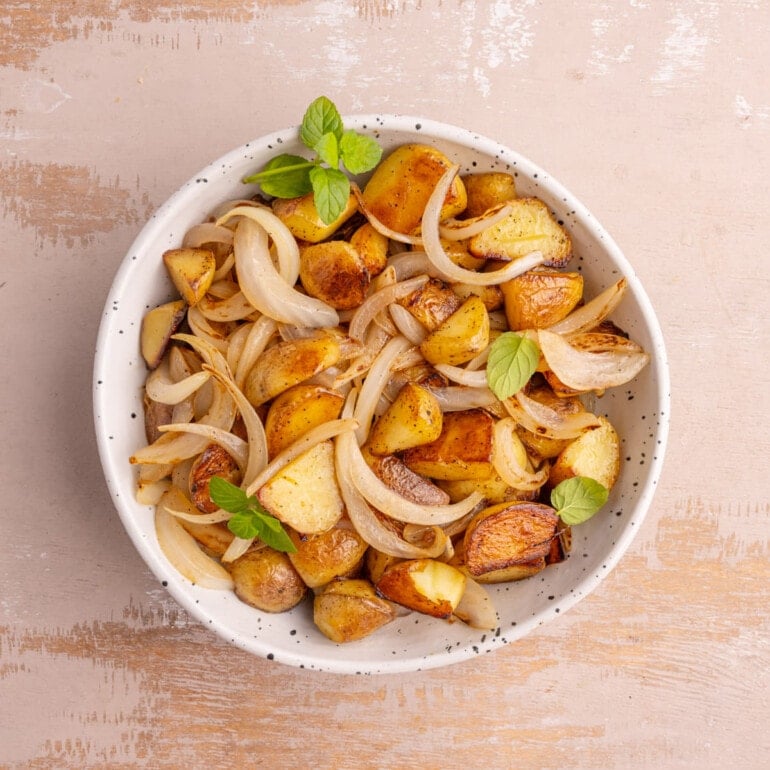 Pan-Fried Potatoes and Onions garnished with basil