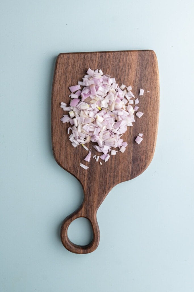 Dicing shallots on a chopping board