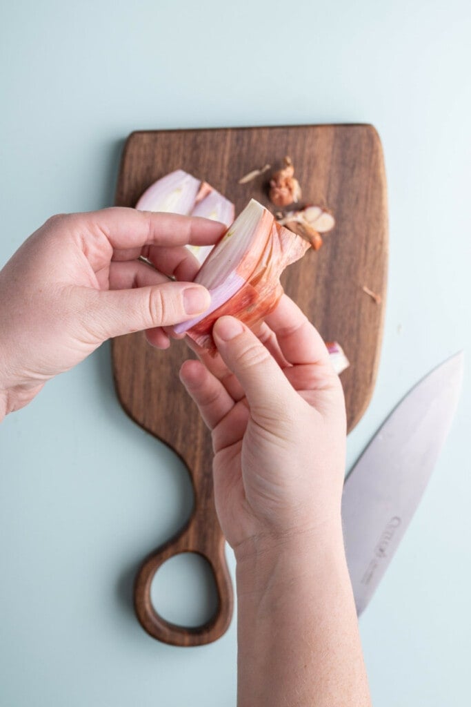 Peeling and discarding outer layer of shallot