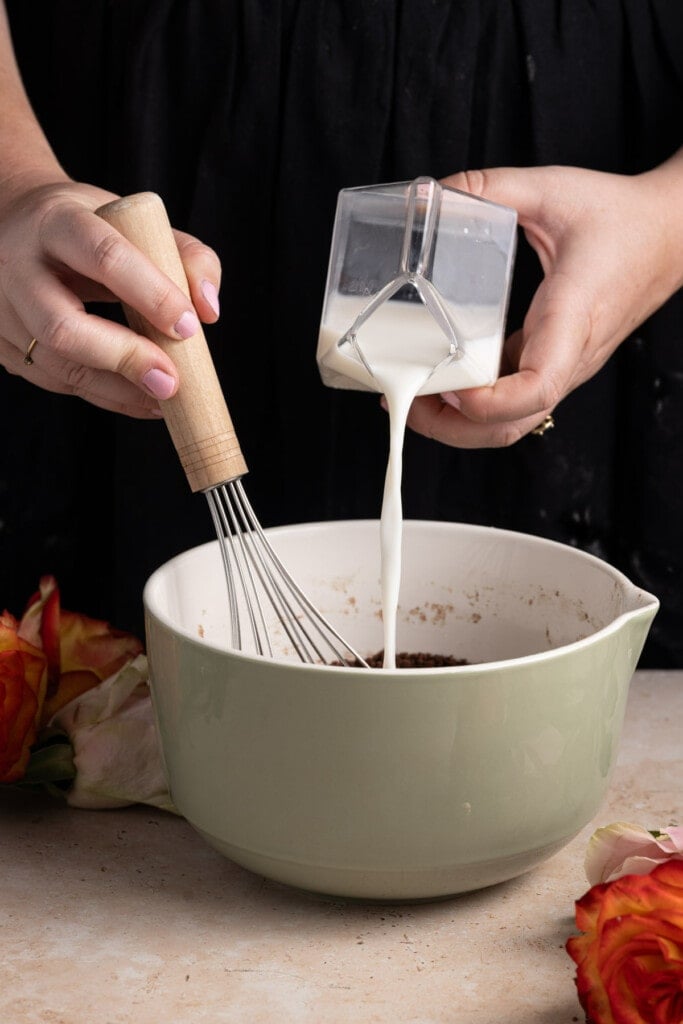 Thinning out edible brownie batter with milk.